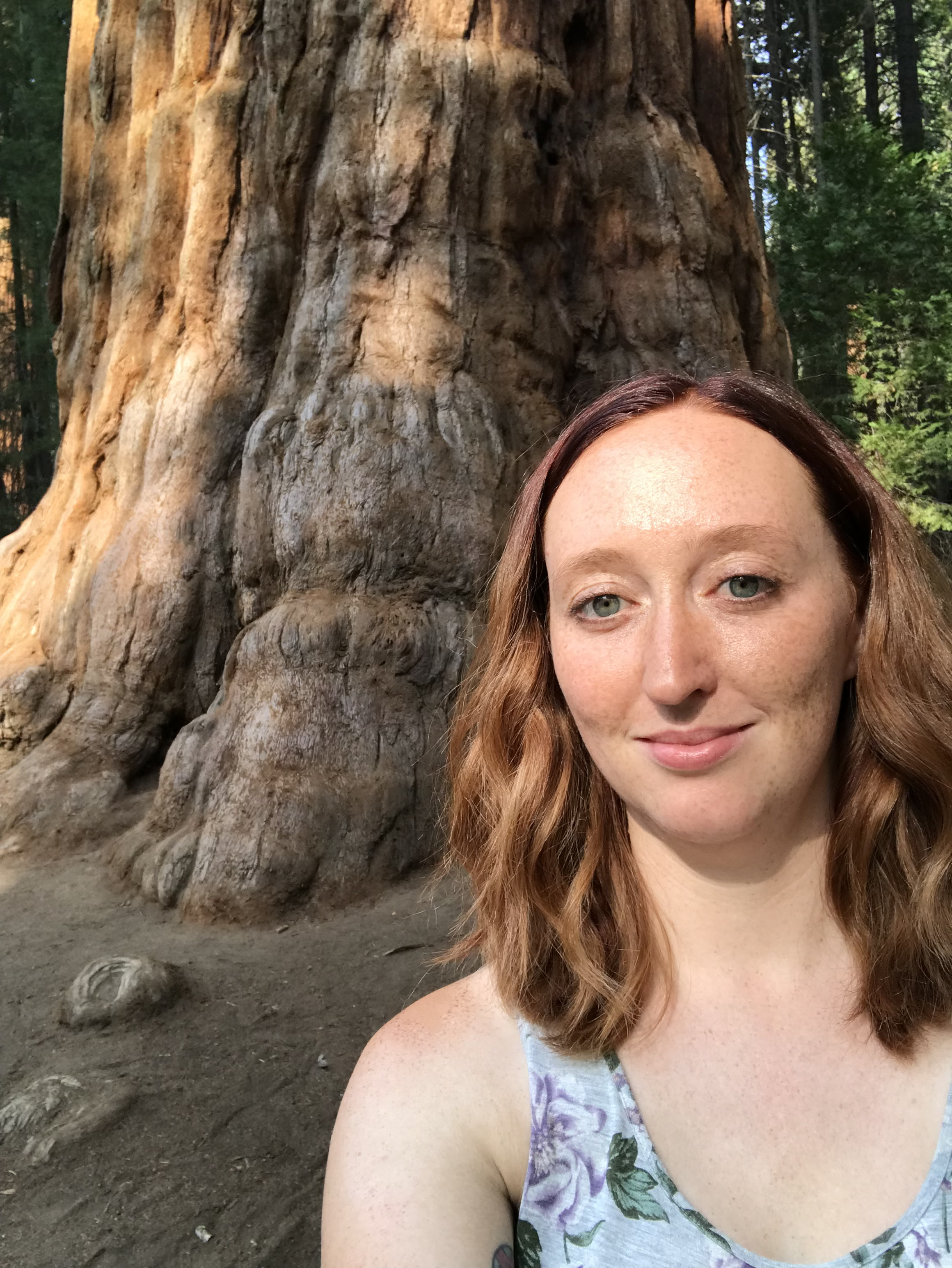 woman standing in front of large tree